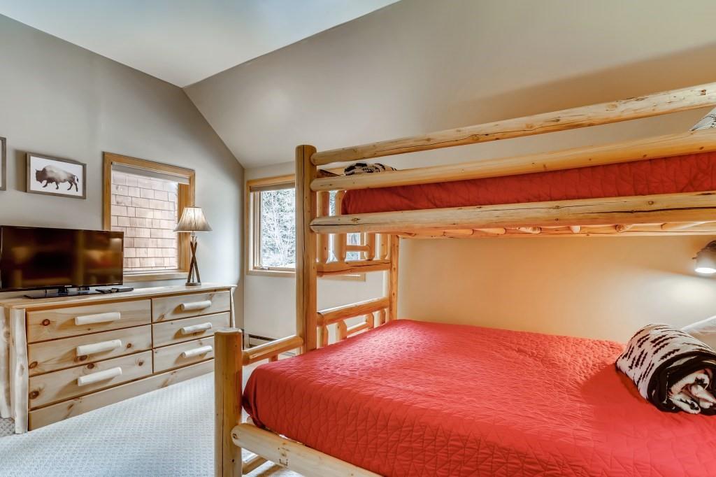 2017 Soda Ridge Road, Unit 1938 Keystone, CO 80435 - Photo 18 of 31 a bedroom with a bed and a flat screen tv