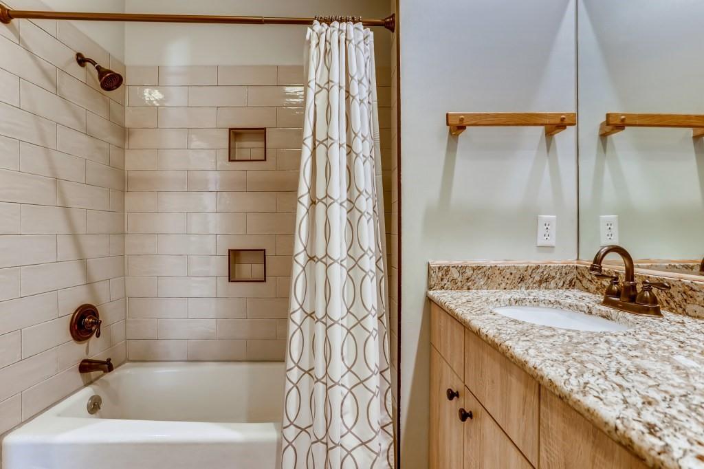 2017 Soda Ridge Road, Unit 1938 Keystone, CO 80435 - Photo 20 of 31 a bathroom with a granite countertop sink a mirror and shower