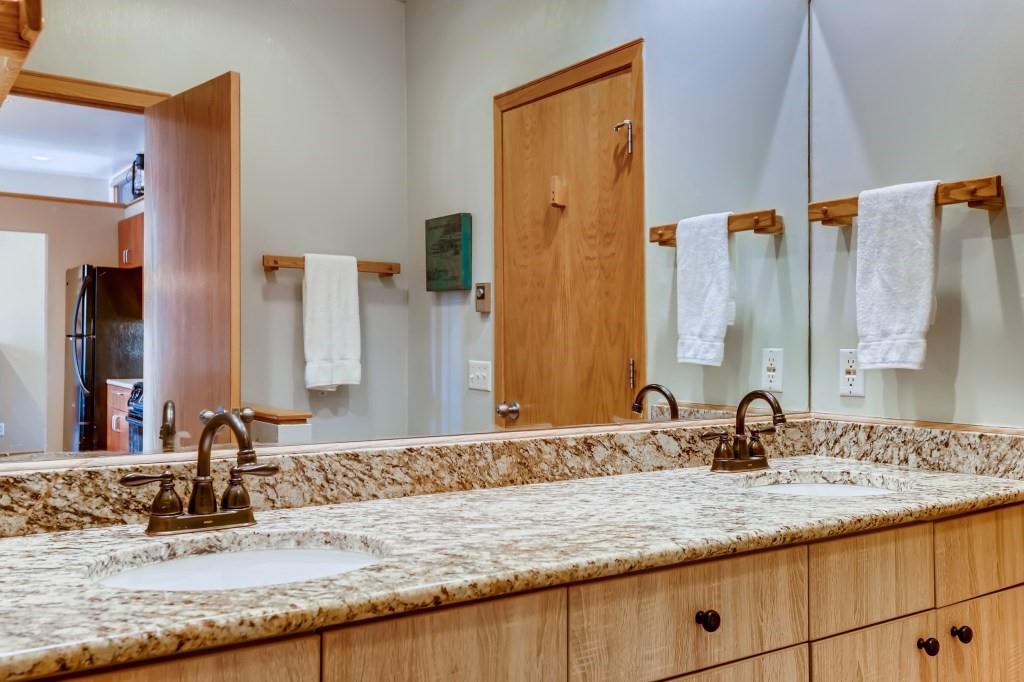 2017 Soda Ridge Road, Unit 1938 Keystone, CO 80435 - Photo 21 of 31 a bathroom with a granite countertop sink and a mirror