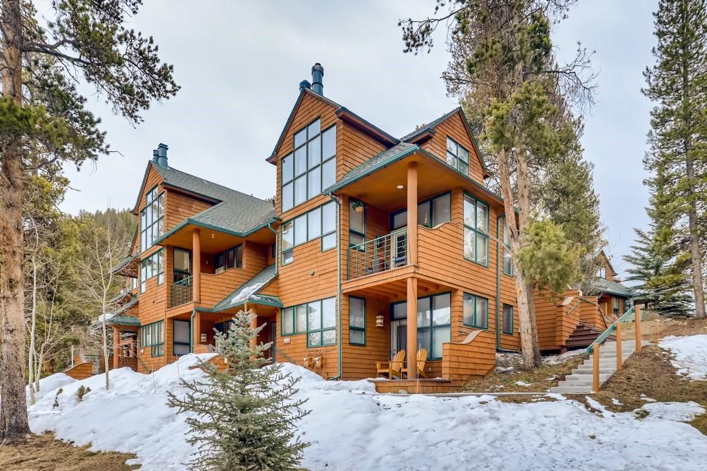 2017 Soda Ridge Road, Unit 1938 Keystone, CO 80435 - Photo 25 of 31 a view of a white house with large windows and a tree