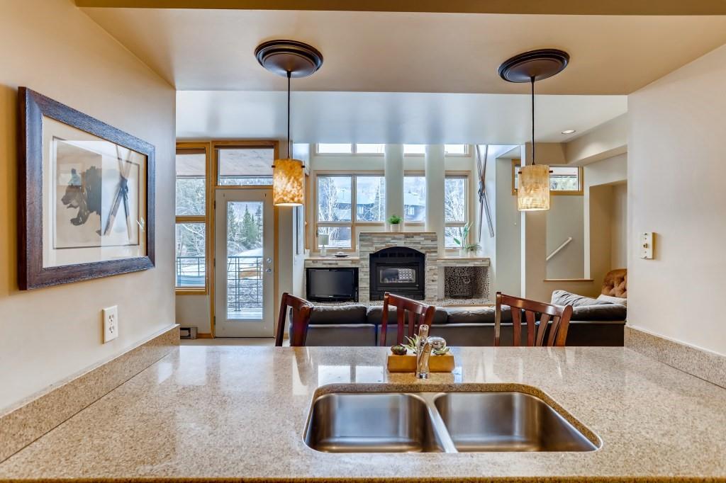 2017 Soda Ridge Road, Unit 1938 Keystone, CO 80435 - Photo 10 of 31 a kitchen with a sink a counter top space and a chandelier