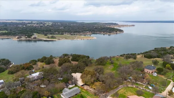 a view of a lake with houses in the back