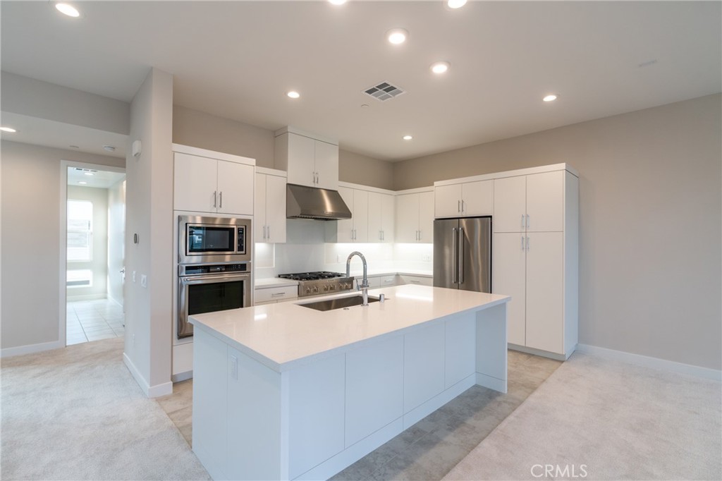 210 Pin Lane Lake Forest, CA 92630 - Photo 11 of 22 a kitchen with stainless steel appliances a refrigerator sink and stove