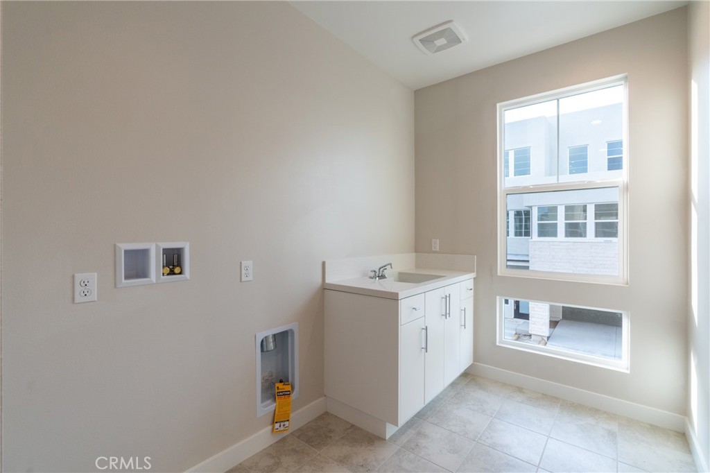 210 Pin Lane Lake Forest, CA 92630 - Photo 13 of 22 a utility room with a sink washer and dryer
