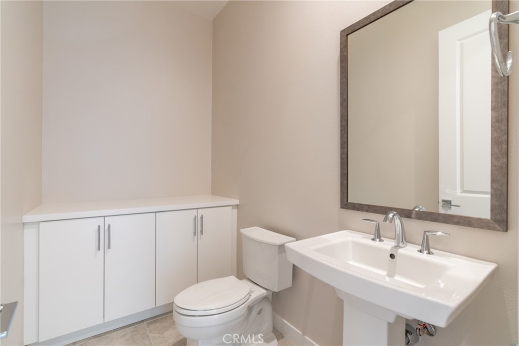 210 Pin Lane Lake Forest, CA 92630 - Photo 17 of 22 a bathroom with a sink a toilet and a mirror