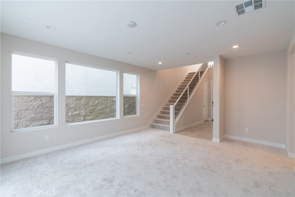 210 Pin Lane Lake Forest, CA 92630 - Photo 21 of 22 a view of an empty room with a window and stairs