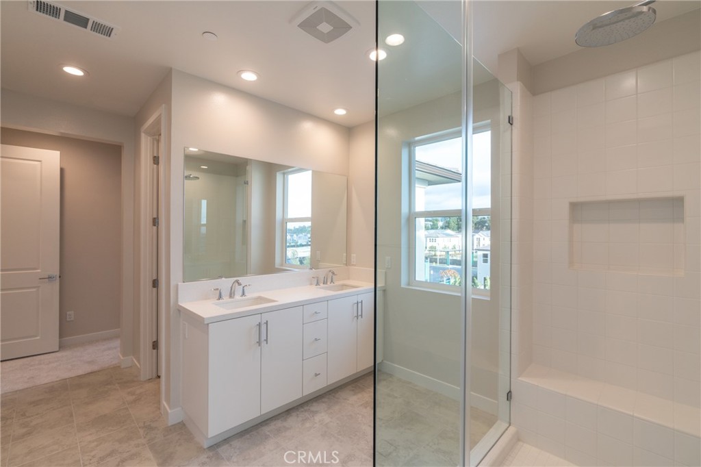 210 Pin Lane Lake Forest, CA 92630 - Photo 3 of 22 a bathroom with a double vanity sink a toilet and shower