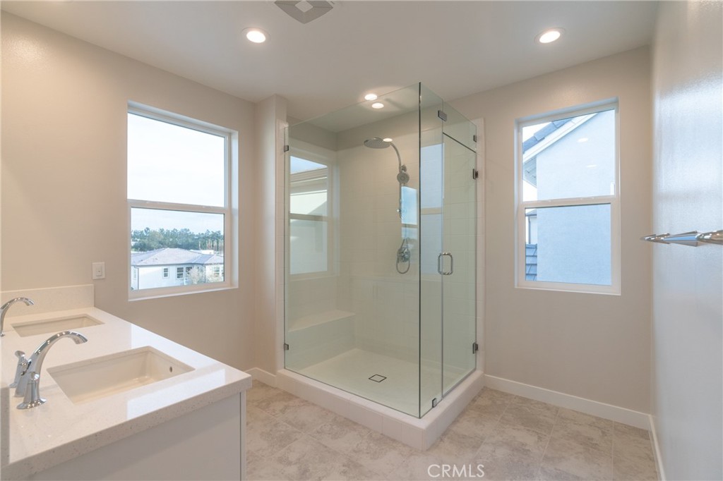 210 Pin Lane Lake Forest, CA 92630 - Photo 4 of 22 a bathroom with a shower sink and mirror