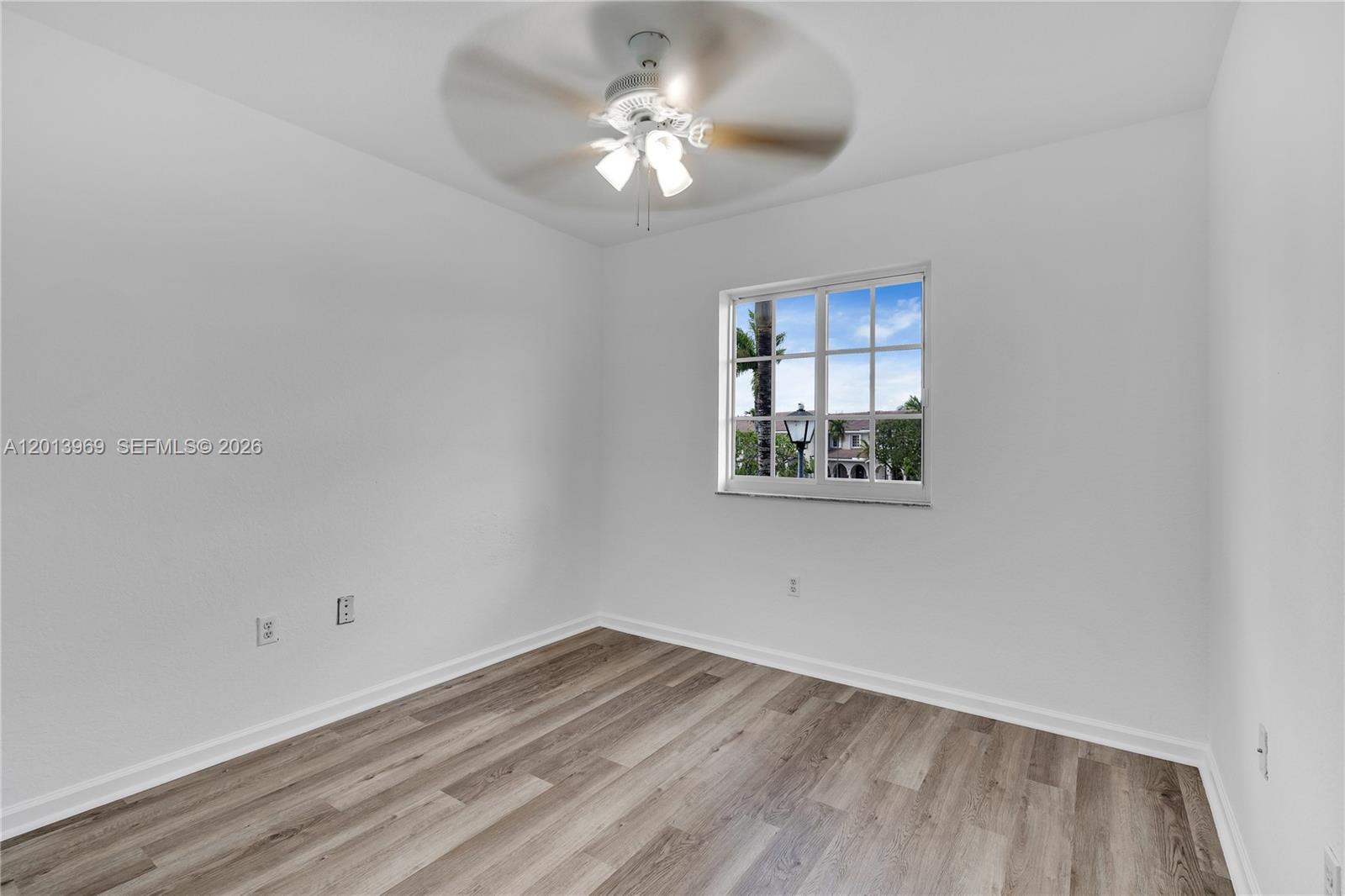 14044 Southwest 273rd Lane, Unit 14044 Homestead, FL 33032 - Photo 23 of 44 wooden floor in an empty room with a window