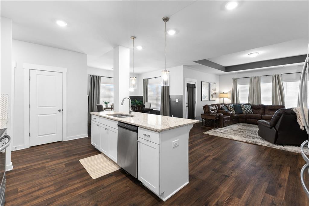2253 Cotton Gin Row Jefferson, GA 30549 - Photo 11 of 45 a open kitchen with sink cabinets and wooden floor