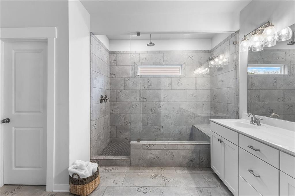 2253 Cotton Gin Row Jefferson, GA 30549 - Photo 21 of 45 a bathroom with a granite countertop sink a toilet and shower