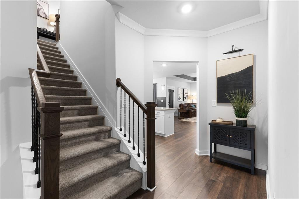 2253 Cotton Gin Row Jefferson, GA 30549 - Photo 25 of 45 a view of a livingroom with wooden floor and stairs