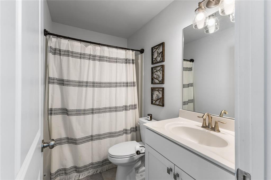 2253 Cotton Gin Row Jefferson, GA 30549 - Photo 28 of 45 a bathroom with a granite countertop sink toilet and shower