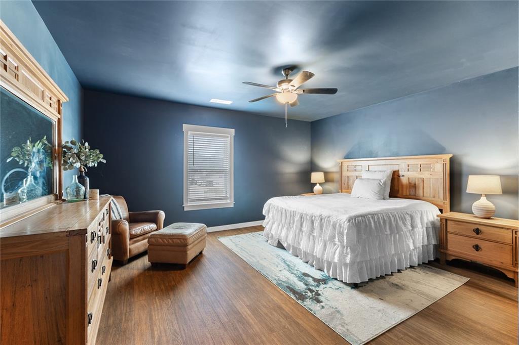 2253 Cotton Gin Row Jefferson, GA 30549 - Photo 38 of 45 a bedroom with a large bed and a chandelier