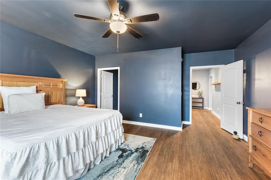 2253 Cotton Gin Row Jefferson, GA 30549 - Photo 39 of 45 a bedroom with a large bed and a chandelier