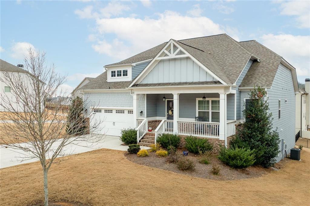 2253 Cotton Gin Row Jefferson, GA 30549 - Photo 5 of 45 a front view of a house with a yard and potted plants
