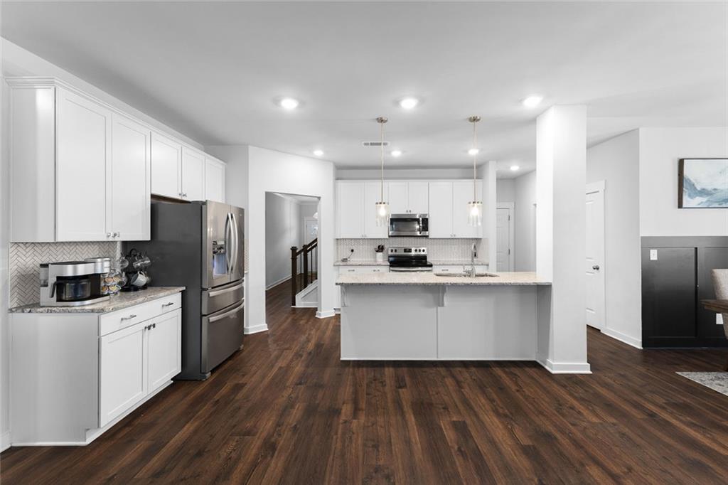 2253 Cotton Gin Row Jefferson, GA 30549 - Photo 10 of 45 a kitchen with refrigerator cabinets and wooden floor