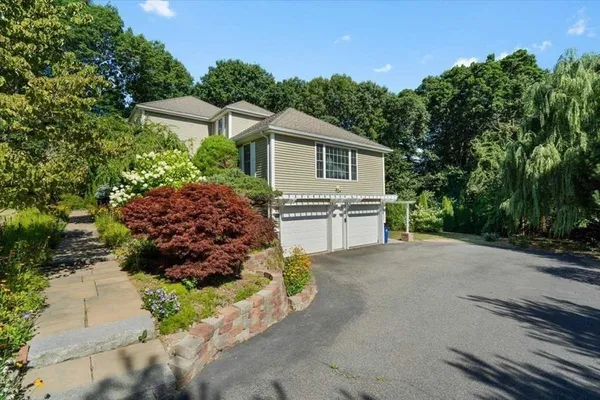 a view of a house with a yard and street