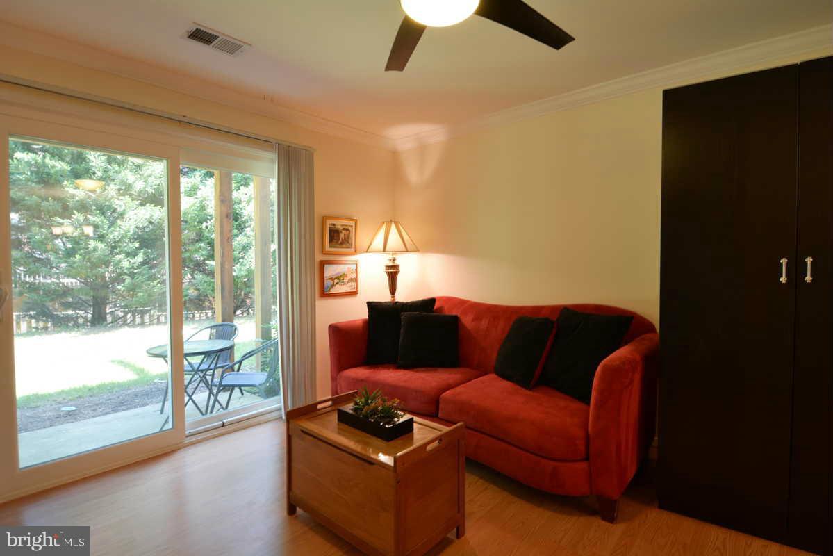 7702 Lexton Place, Unit A Springfield, VA 22152 - Photo 12 of 22 a living room with furniture and a floor to ceiling window