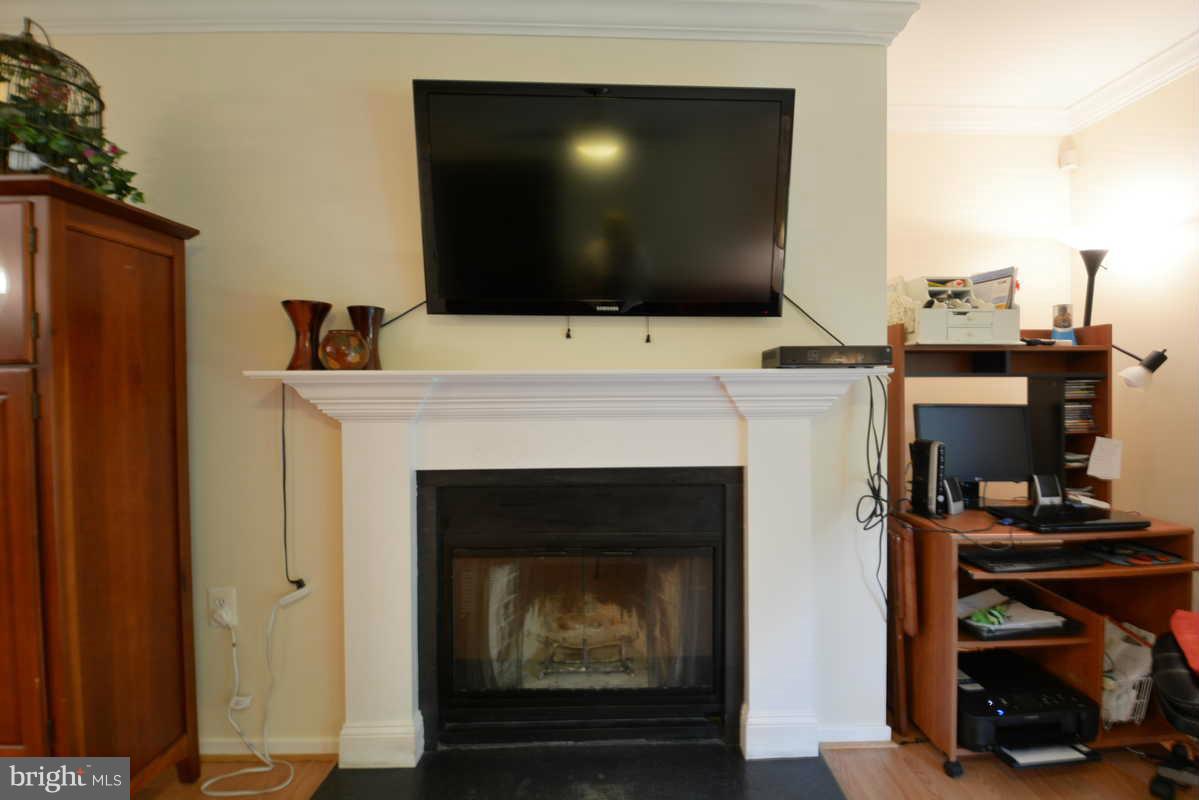 7702 Lexton Place, Unit A Springfield, VA 22152 - Photo 13 of 22 a living room with a fireplace furniture and a flat screen tv