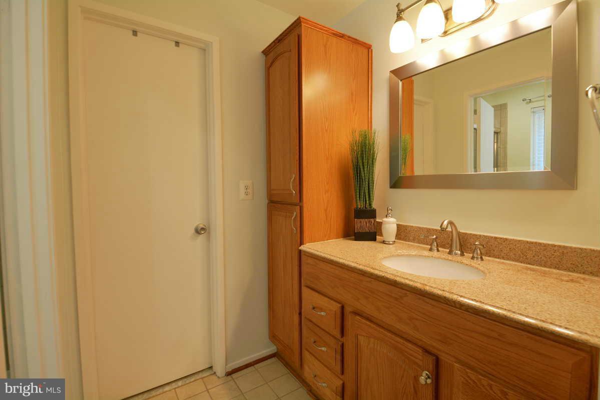 7702 Lexton Place, Unit A Springfield, VA 22152 - Photo 15 of 22 a bathroom with a sink and a mirror