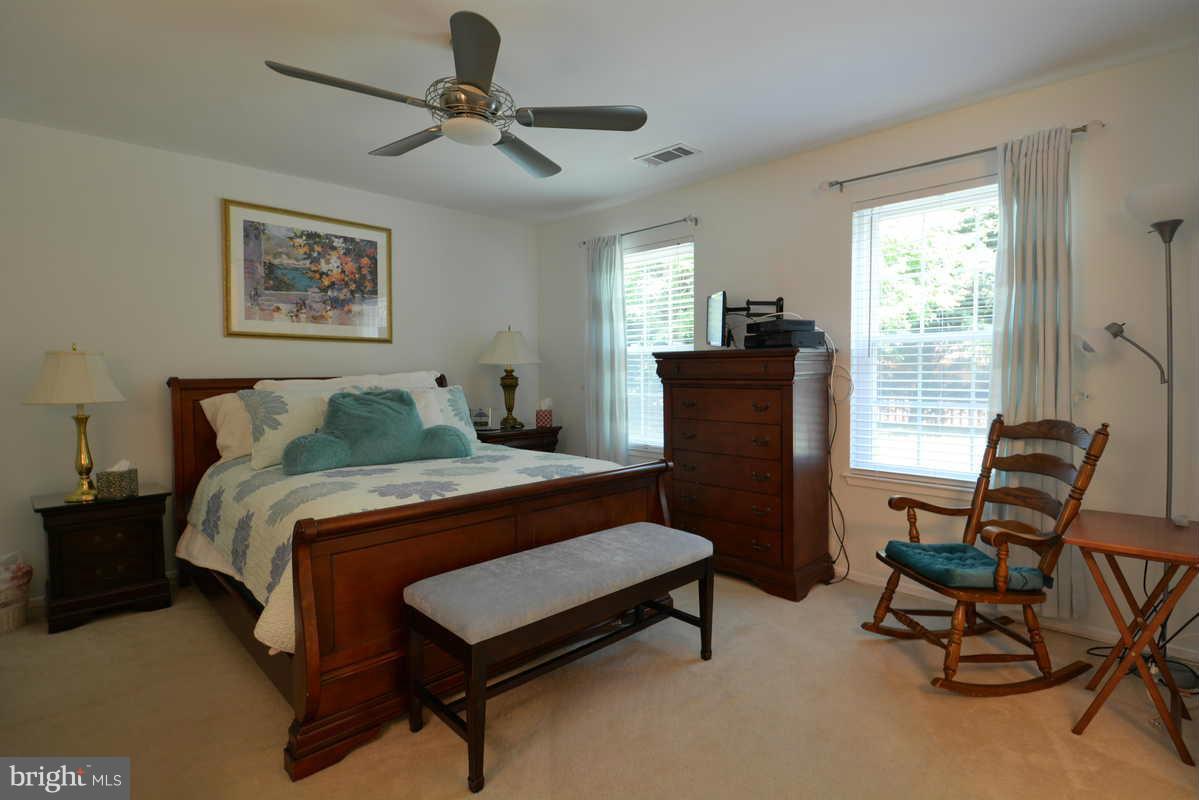 7702 Lexton Place, Unit A Springfield, VA 22152 - Photo 16 of 22 a bedroom with a bed and chair