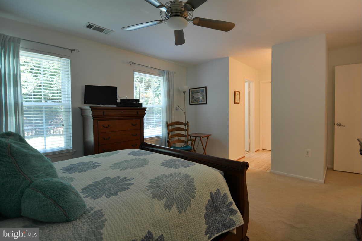 7702 Lexton Place, Unit A Springfield, VA 22152 - Photo 17 of 22 a bedroom with a bed and a television