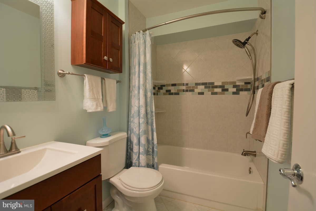 7702 Lexton Place, Unit A Springfield, VA 22152 - Photo 18 of 22 a bathroom with a sink a toilet and shower