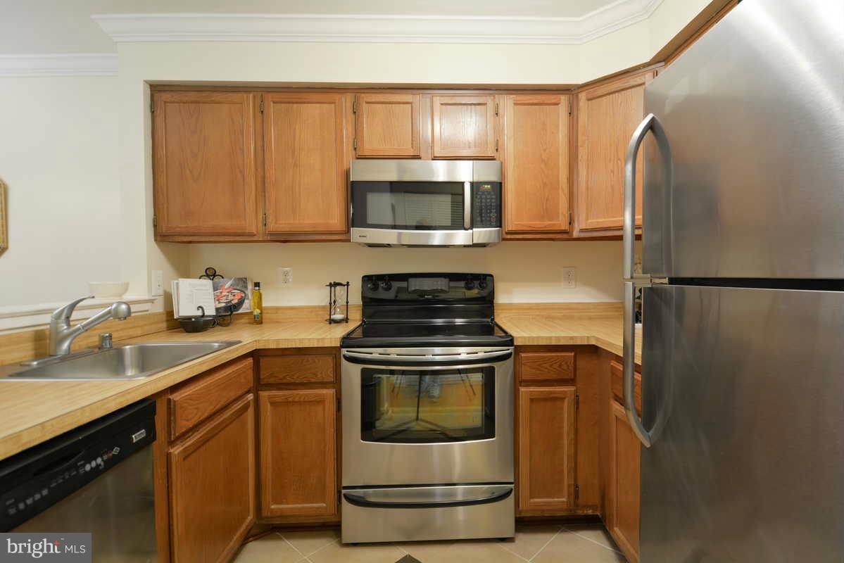 7702 Lexton Place, Unit A Springfield, VA 22152 - Photo 6 of 22 a kitchen with a stove and a microwave