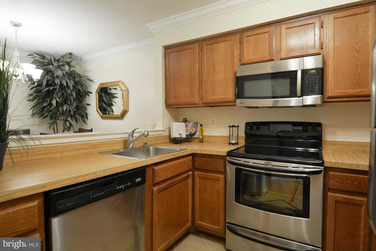 7702 Lexton Place, Unit A Springfield, VA 22152 - Photo 7 of 22 a kitchen with a stove and a microwave