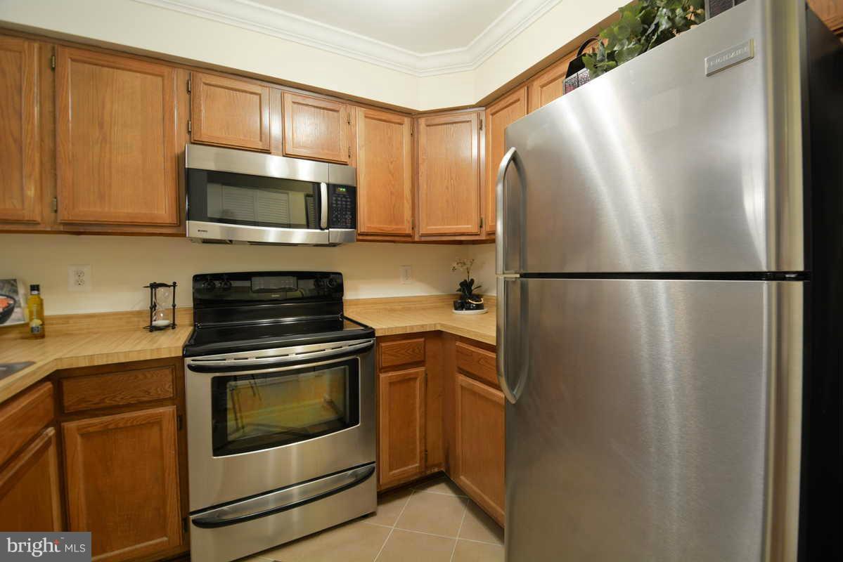 7702 Lexton Place, Unit A Springfield, VA 22152 - Photo 8 of 22 a kitchen with cabinets and steel stainless steel appliances