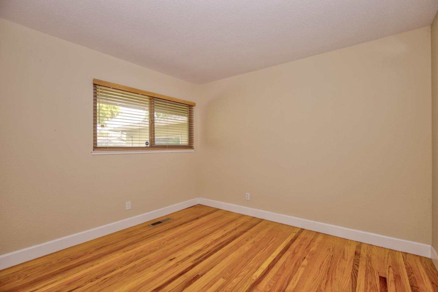 2843 Aragon Way San Jose, CA 95125 - Photo 17 of 26 a view of an empty room with wooden floor and a window