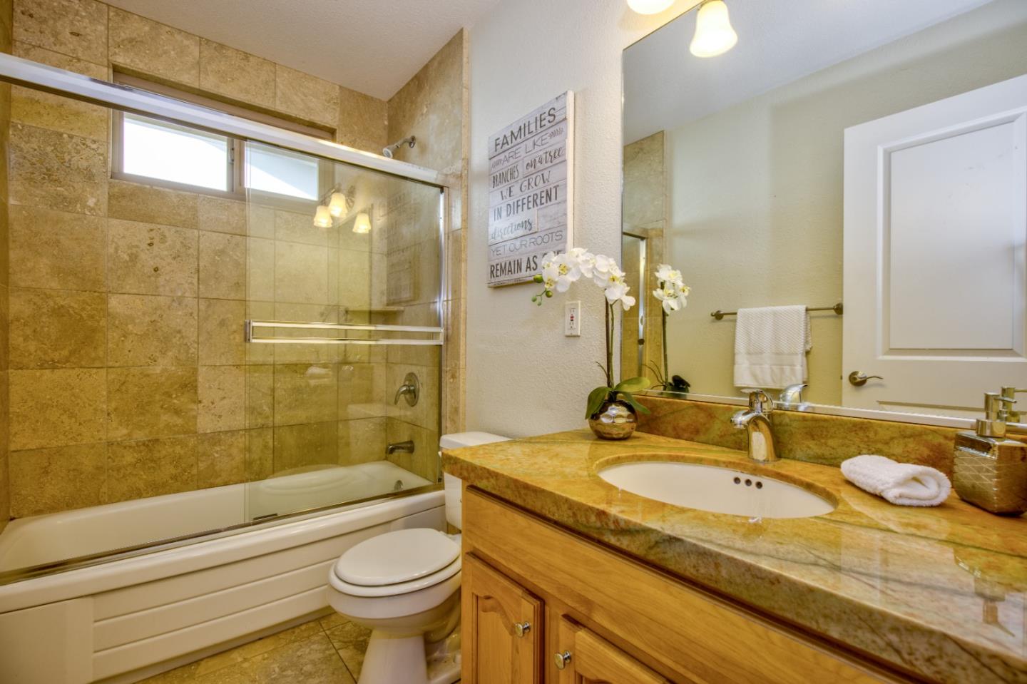 2843 Aragon Way San Jose, CA 95125 - Photo 18 of 26 a bathroom with a granite countertop sink a toilet a mirror and shower