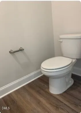 a white toilet sitting next to a shower