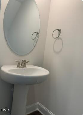 6927 Eddy Point Lane Raleigh, NC 27616 - Photo 21 of 27 a bathroom with a sink a toilet and mirror