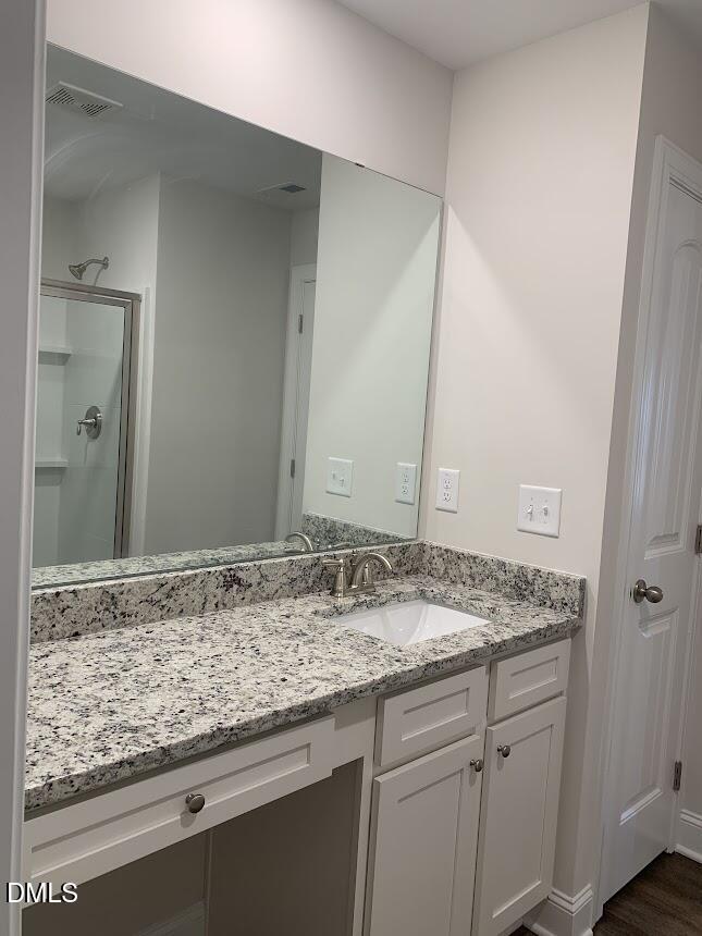 6927 Eddy Point Lane Raleigh, NC 27616 - Photo 23 of 27 a bathroom with a granite countertop sink and a mirror
