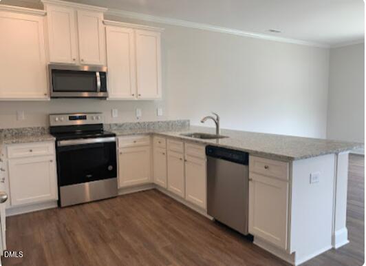 6927 Eddy Point Lane Raleigh, NC 27616 - Photo 4 of 27 a kitchen with stainless steel appliances a sink a stove a microwave and cabinets
