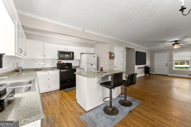 a view of kitchen with counter top space cabinets and appliances
