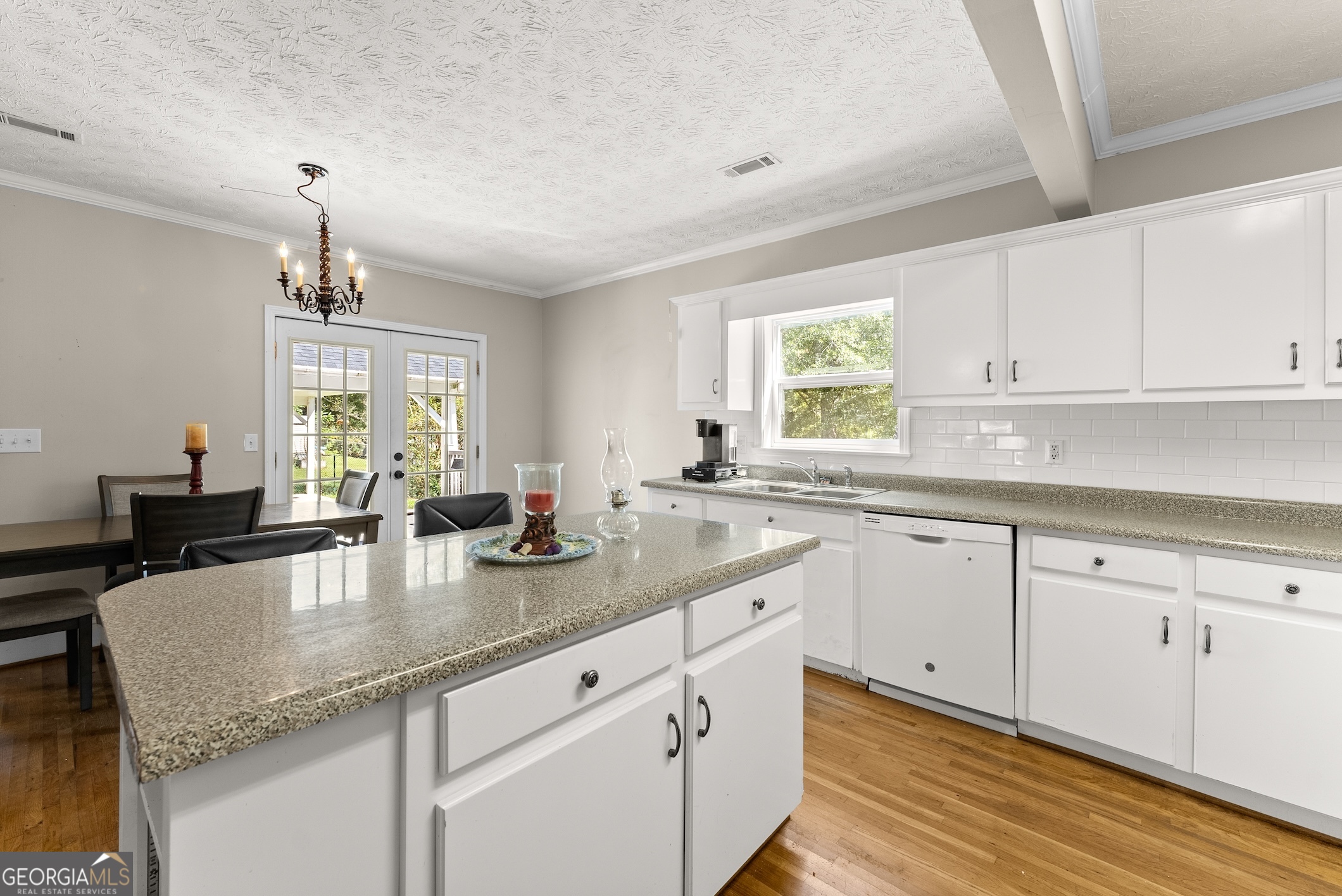 2003 West Currahee Street Toccoa, GA 30577 - Photo 13 of 34 a kitchen with granite countertop white cabinets white appliances a sink and a window