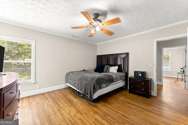 a bedroom with a large bed and a chandelier