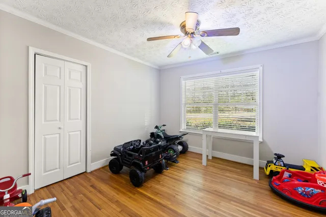 a kids room with toys and wooden floor
