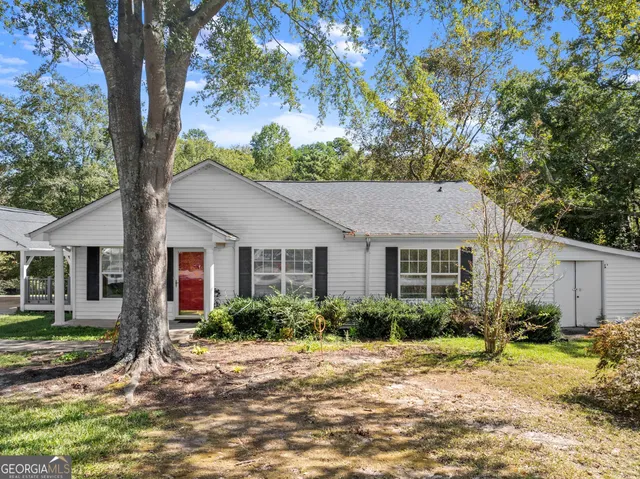 a house that has a tree in front of it
