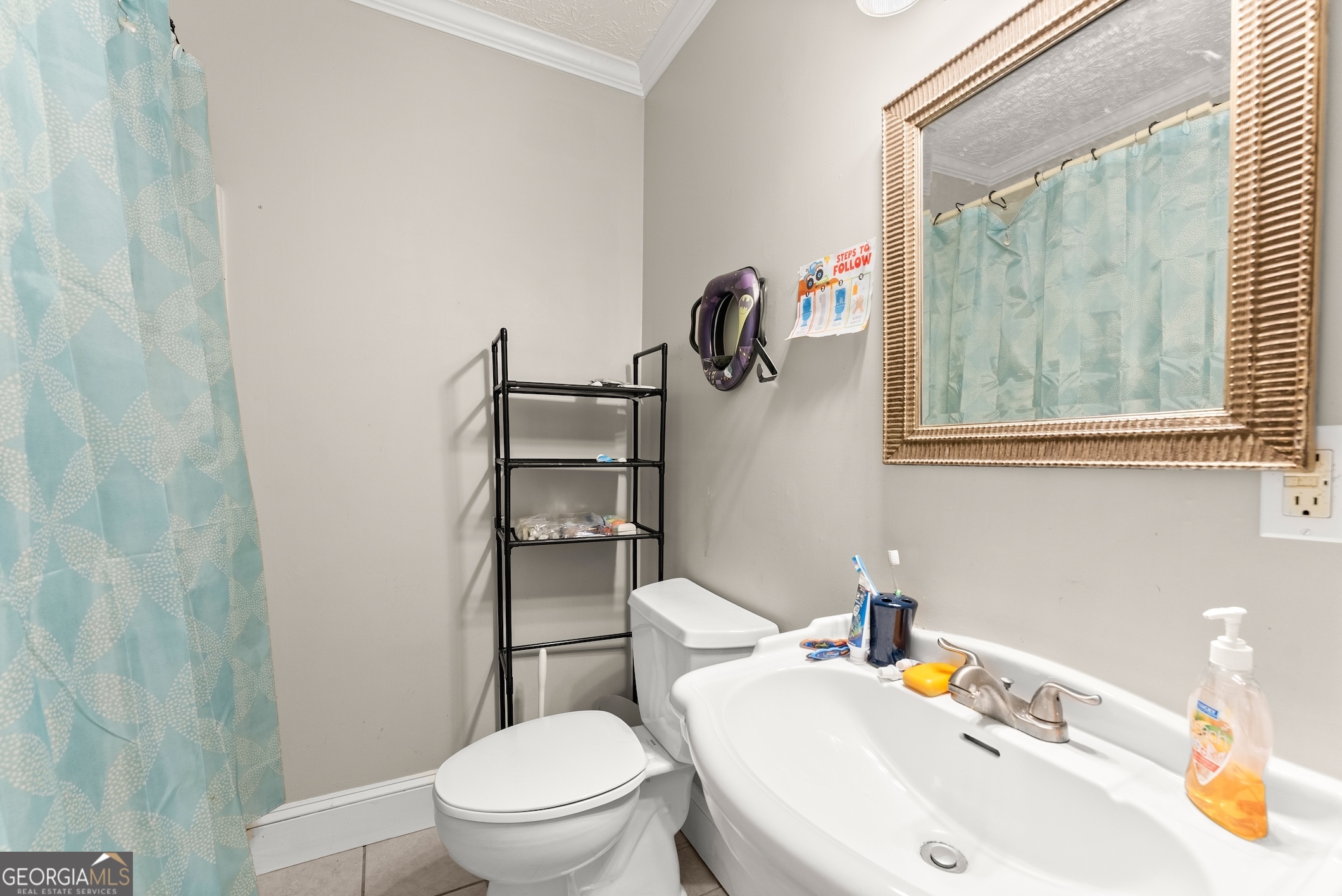 2003 West Currahee Street Toccoa, GA 30577 - Photo 24 of 34 a white toilet sitting next to a bathroom sink