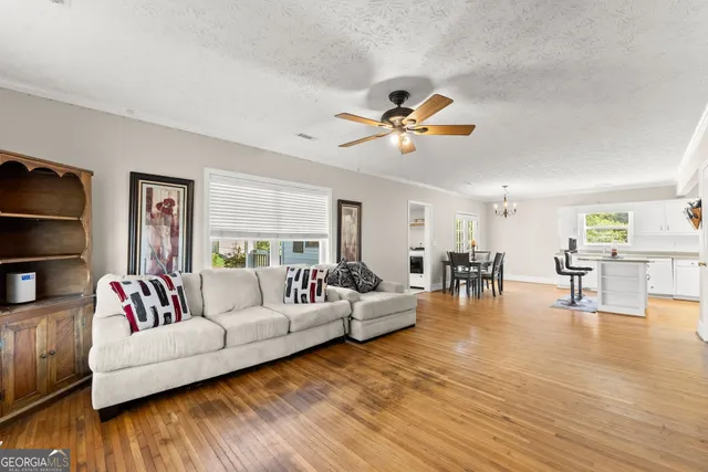 a living room with furniture and wooden floor