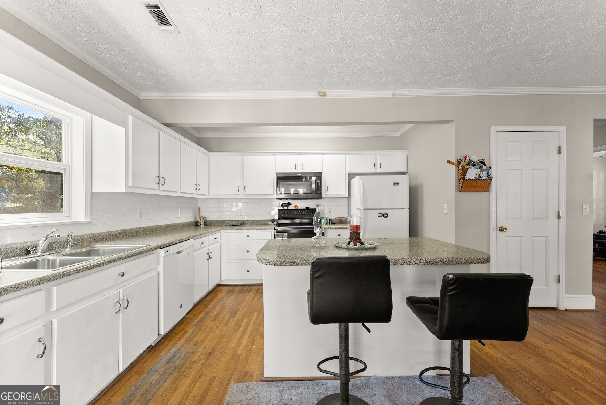 2003 West Currahee Street Toccoa, GA 30577 - Photo 10 of 34 a kitchen with granite countertop a sink cabinets and window