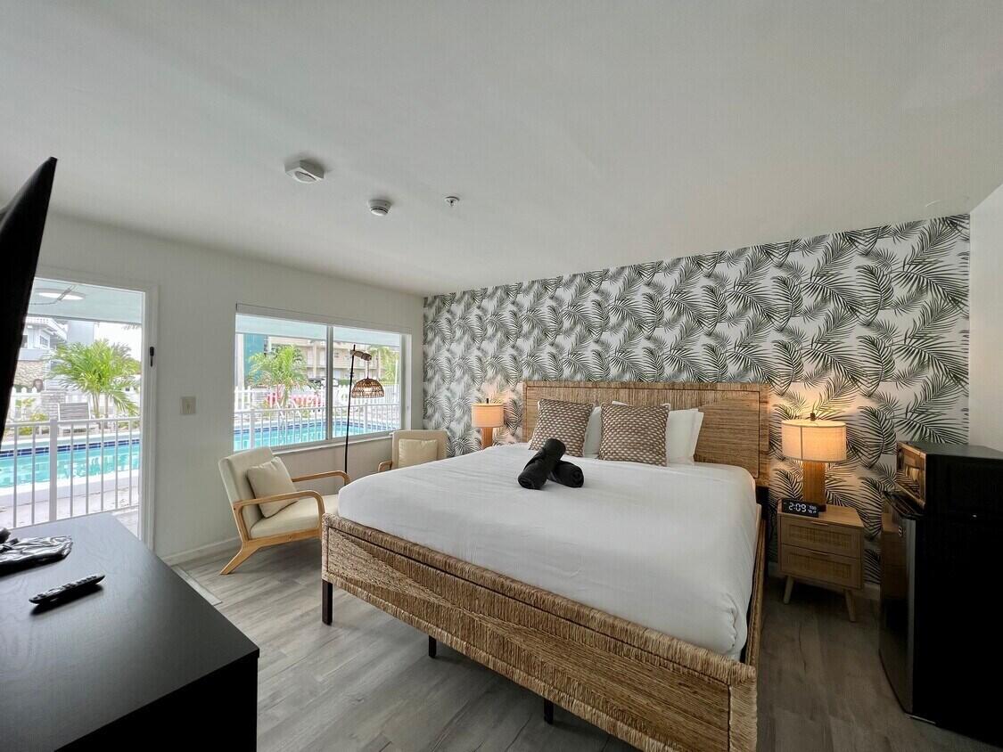 1020 North Riverside Drive Pompano Beach, FL 33062 - Photo 15 of 32 a bedroom with a bed and large windows