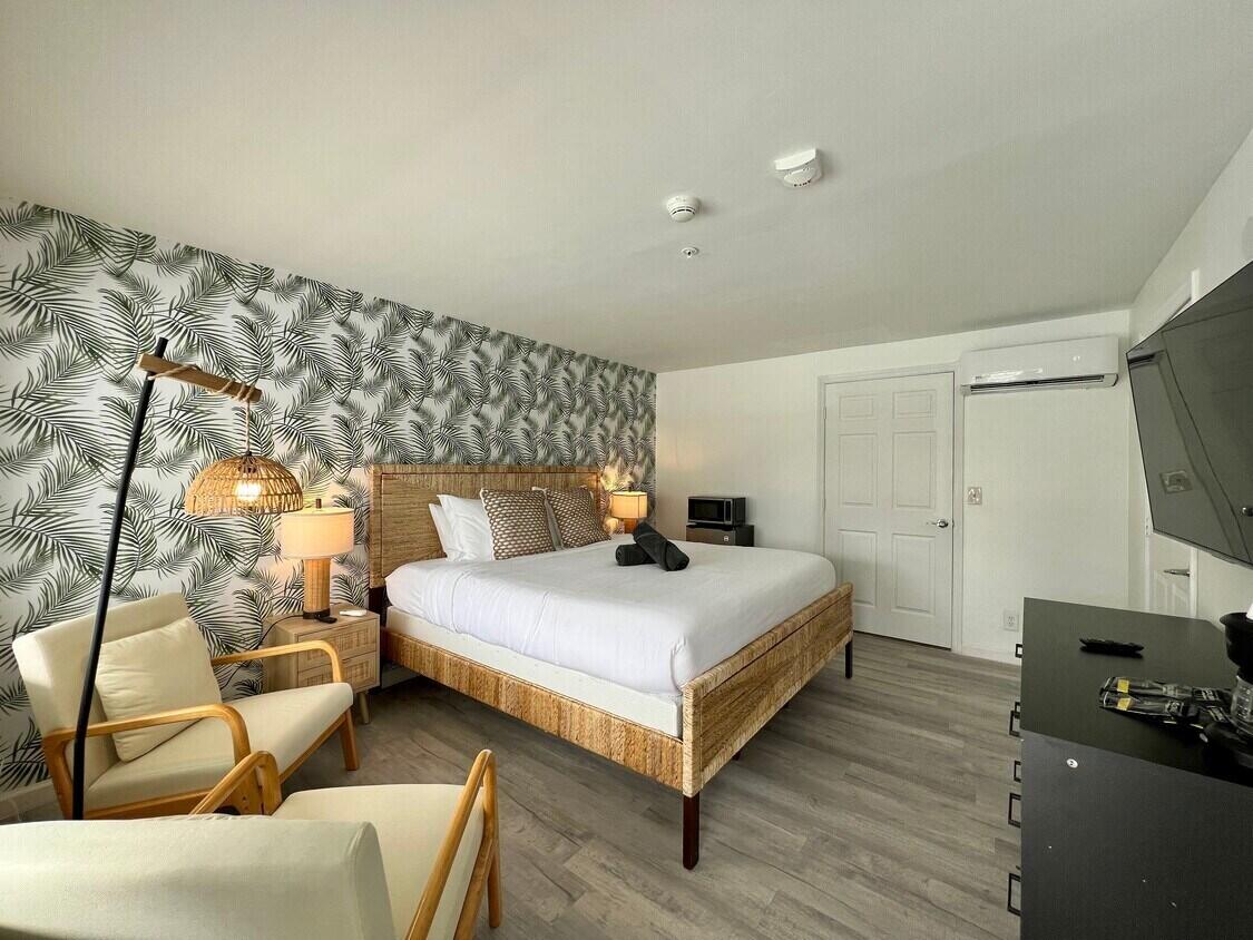 1020 North Riverside Drive Pompano Beach, FL 33062 - Photo 17 of 32 a bedroom with a bed and a flat screen tv