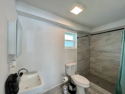 a bedroom with two beds and wooden floor