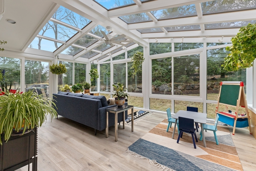 7 Derosier Drive Middleton, MA 01949 - Photo 16 of 42 a living room with furniture floor to ceiling windows and a potted plant