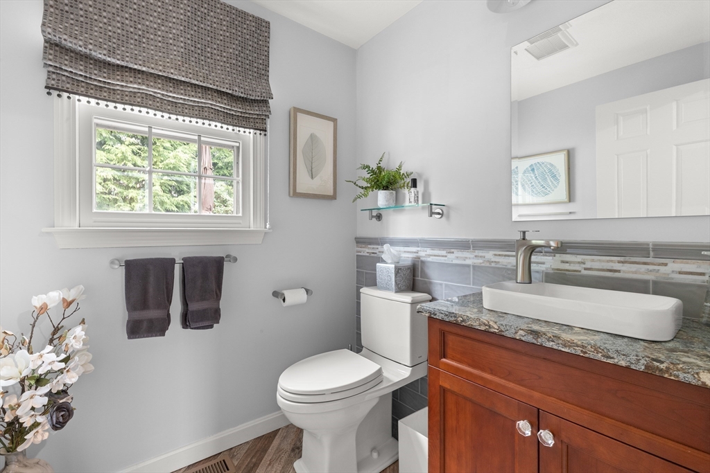 7 Derosier Drive Middleton, MA 01949 - Photo 20 of 42 a bathroom with a toilet sink and mirror